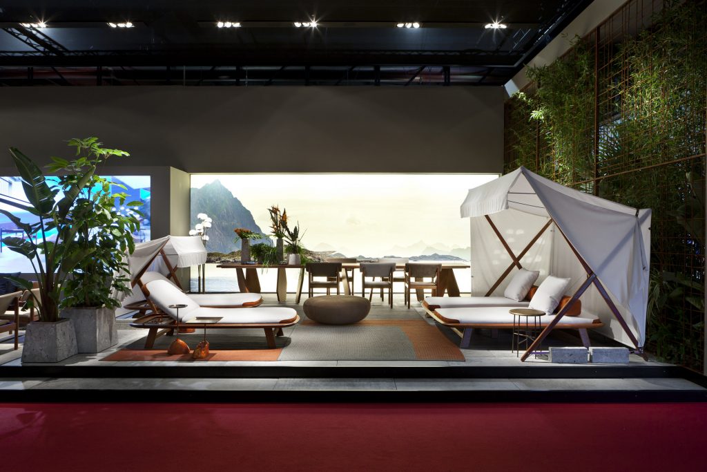 Three 10th Tellaro Sun Loungers: White cushioned sun lounger with an adjustable backrest and wooden frame in a showroom.