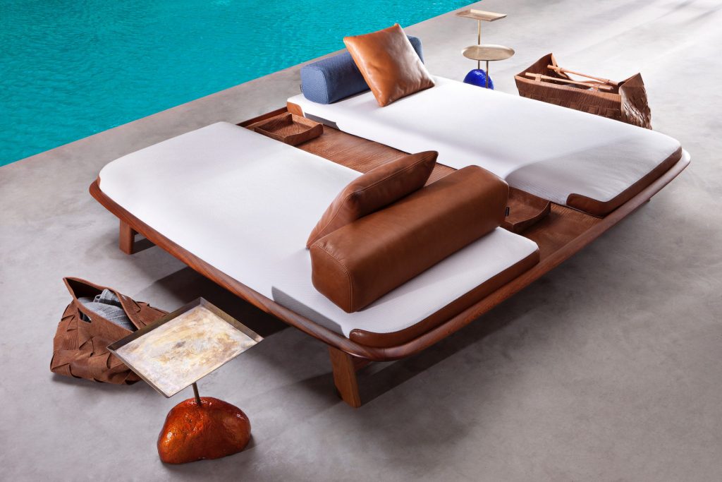 10th Tellaro Sun Lounger: White cushioned sun lounger with an adjustable backrest and wooden frame next to a pool.