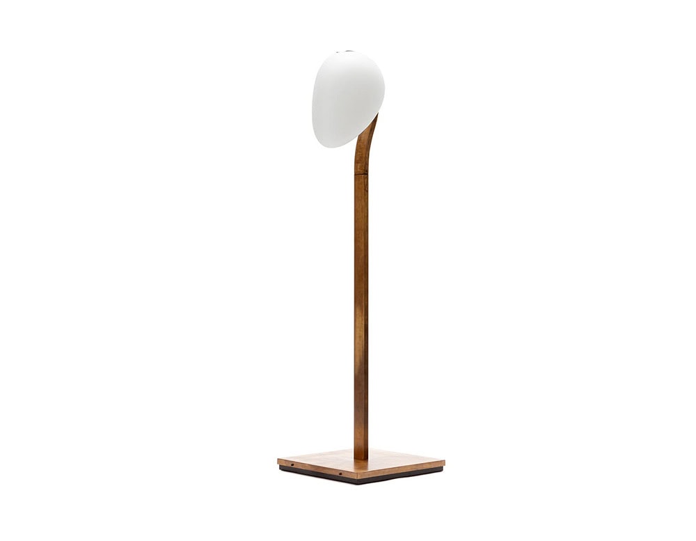 A studio shot of the 10th Tree Light Outdoor Floor Light showcasing its sleek wooden frame a smooth white diffuser and a sturdy square base