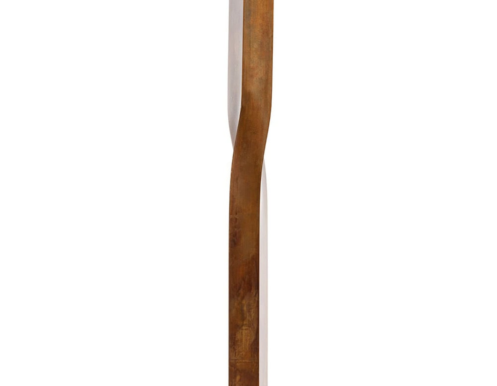 A detailed close-up of the 10th Tree Light Outdoor Floor Light showcasing its elegantly curved wooden frame with a smooth natural finish