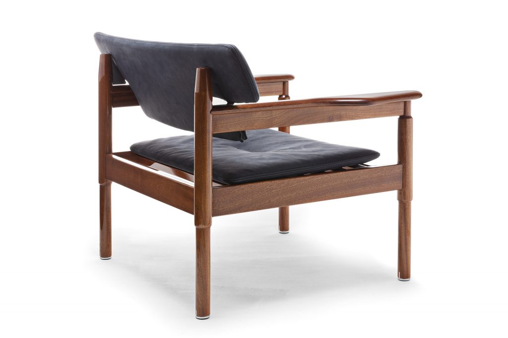 Vieste Armchair: Wooden armchair with a gray cushioned seat with four legs on a white background.