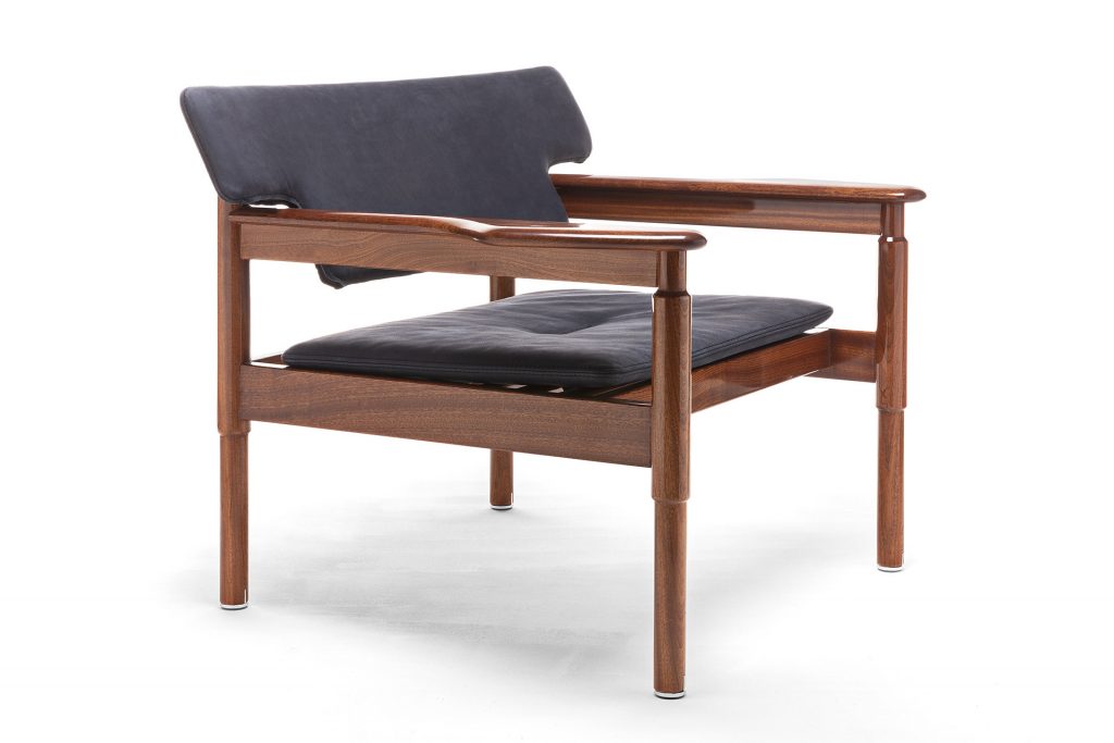 Vieste Armchair: Wooden armchair with a gray cushioned seat with four legs on a white background.