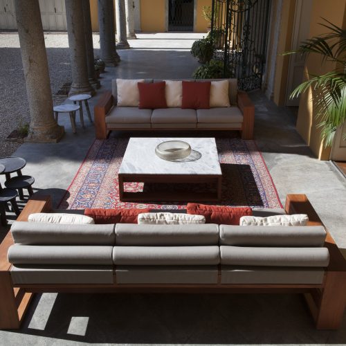 Bellagio Coffee Table: Rectangular top in white and gray marble with a brown base in a living room.