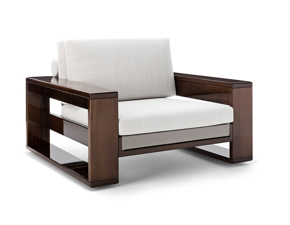A three-quarter view of the Bellagio Outdoor Armchair showcasing its solid wooden frame plush light-colored cushions and elegant contemporary design