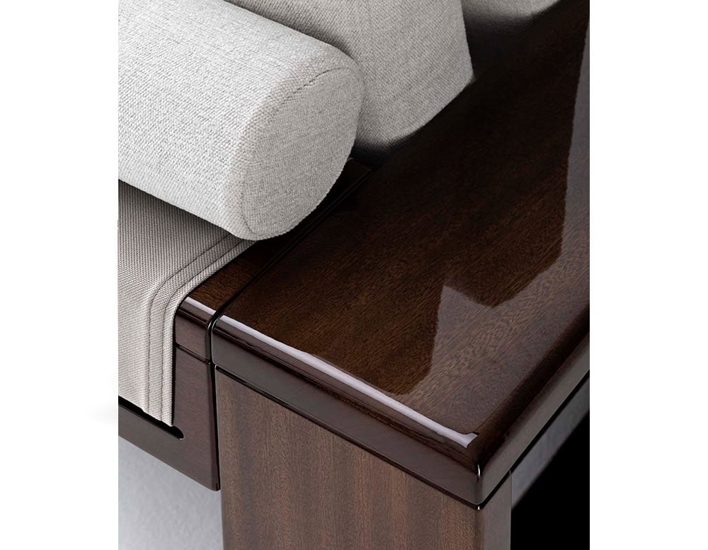 A detailed close-up of the Bellagio Outdoor Armchair highlighting its plush light-colored cushions sleek polished wooden frame and precise craftsmanship