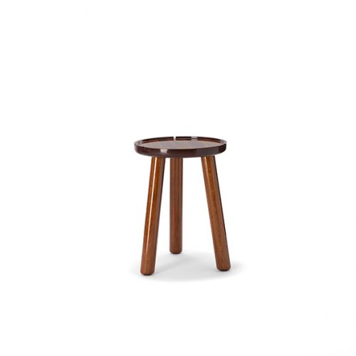 A compact studio shot of a rustic round stool featuring a warm wood finish three sturdy legs and a minimalist design
