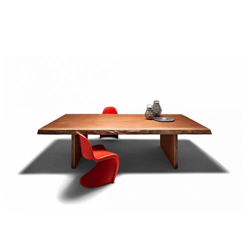 A compact studio shot featuring the Individual Table styled with decorative objects and red seating on a dark rug for a modern aesthetic