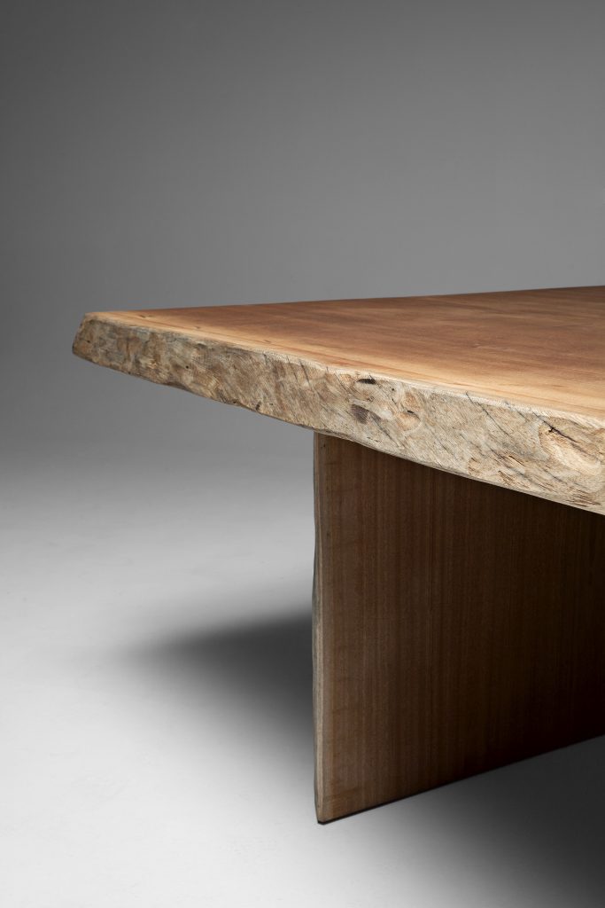 Closeup of Individual Table: Brown wooden rectangular dining table with two rectangular legs on a white background.
