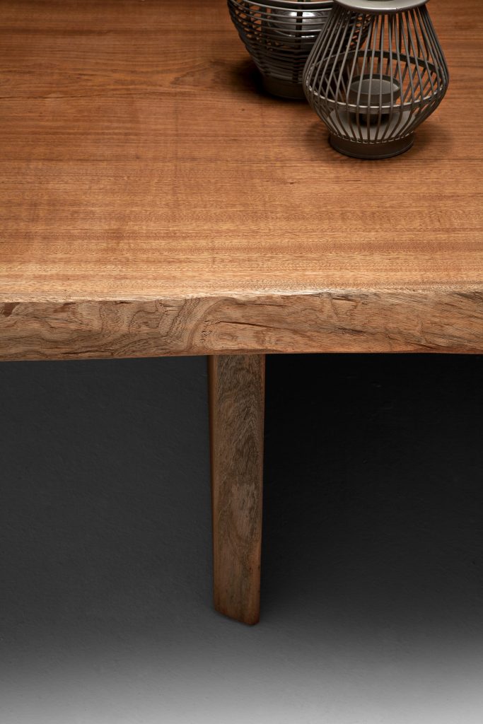 Closeup of Individual Table: Brown wooden rectangular dining table with two rectangular legs on a white background.