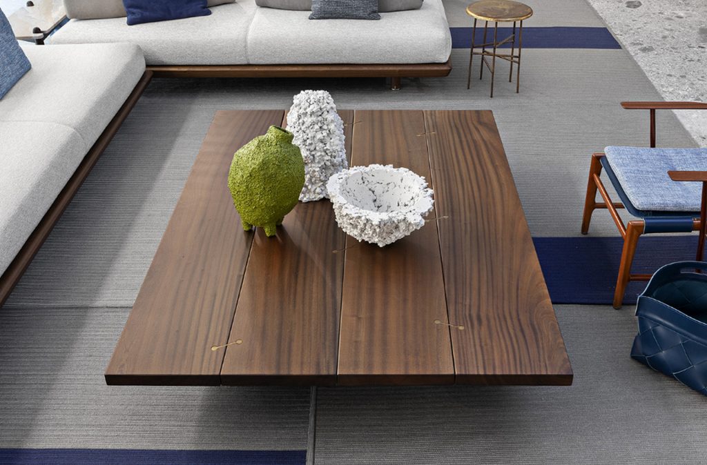 Brown Joint Rectangular Coffee Table: Rectangular top with two legs in a living room.