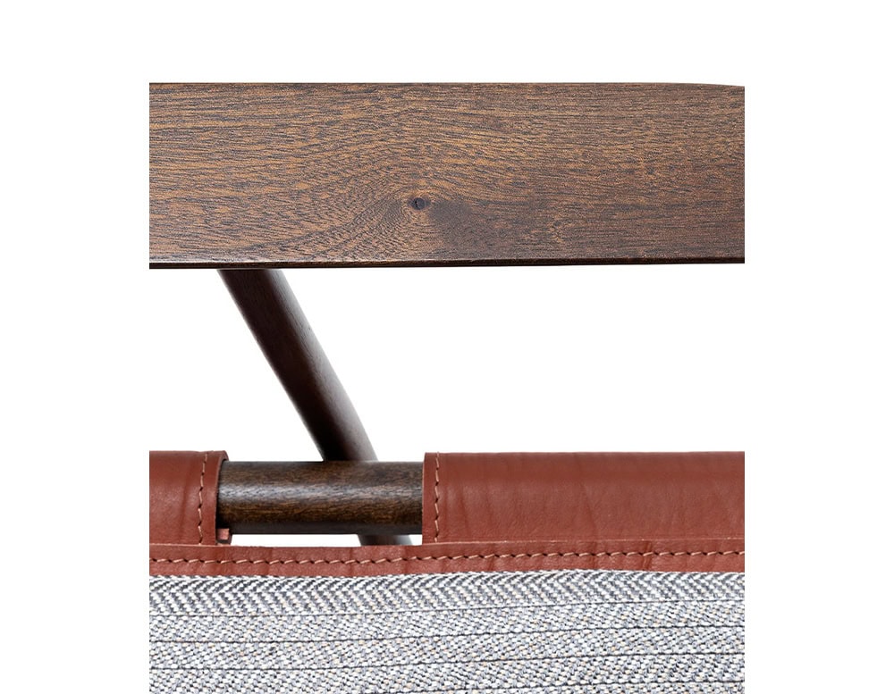 Closeup of Levante Chair. Structure in brown wood; seat in brown and gray cushion on a white background.
