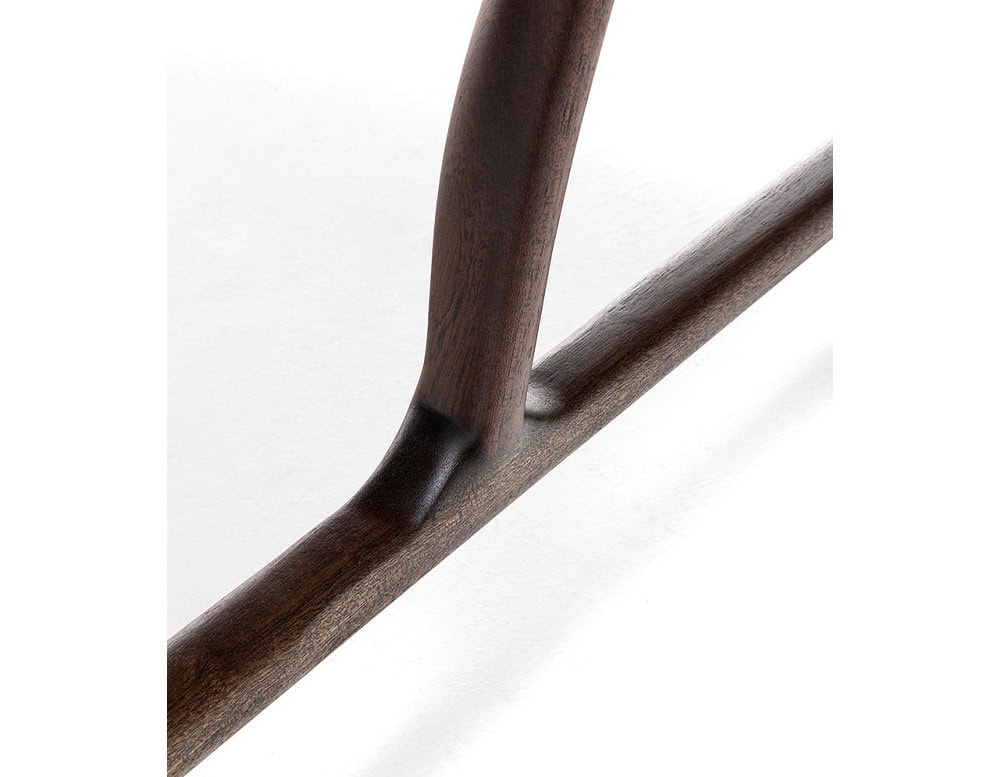 Closeup of Levante Chair. Structure in brown wood on a white background.