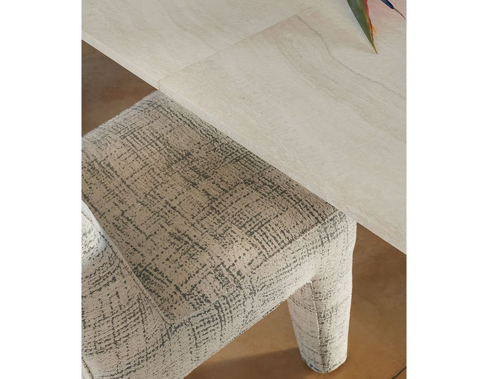 Closeup of Michelangelo Dinner Table in rectangular shape. Top in white with gour gray legs in a dining room.