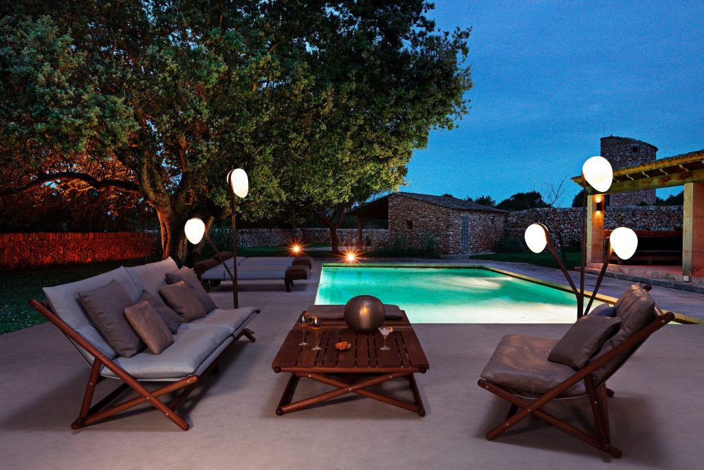 paraggi sofa with white covers next to a pool