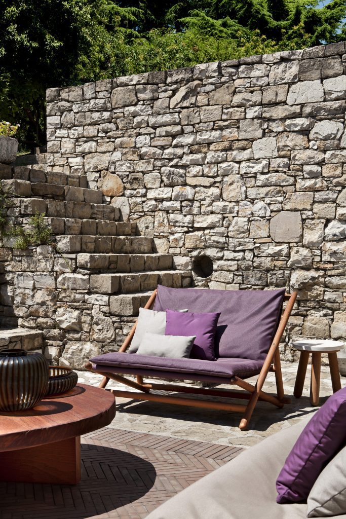 paraggi sofa with purple backrest in an outdoor setting