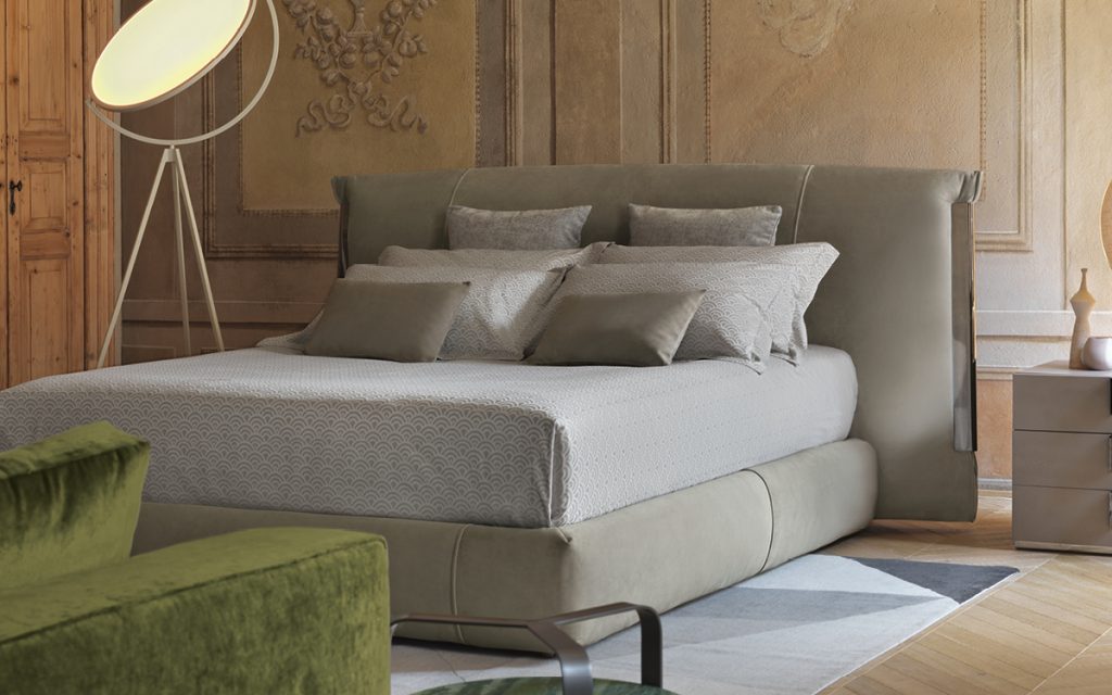amal bed with dark green hearest in a distressed wood room setting