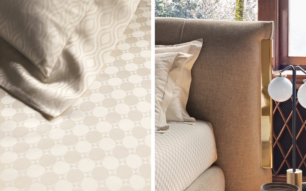 close up of the amal bed with beige fabric next to a table in a room setting