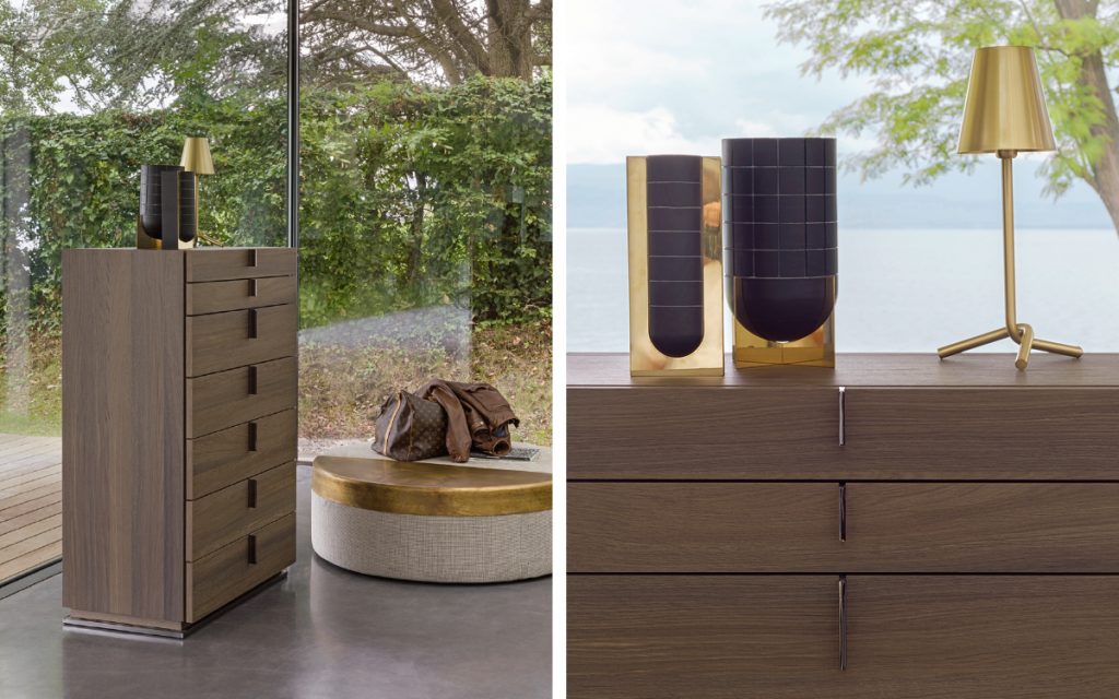Closeup of a brown wood Ari Night Table with drawers and in a bedroom.