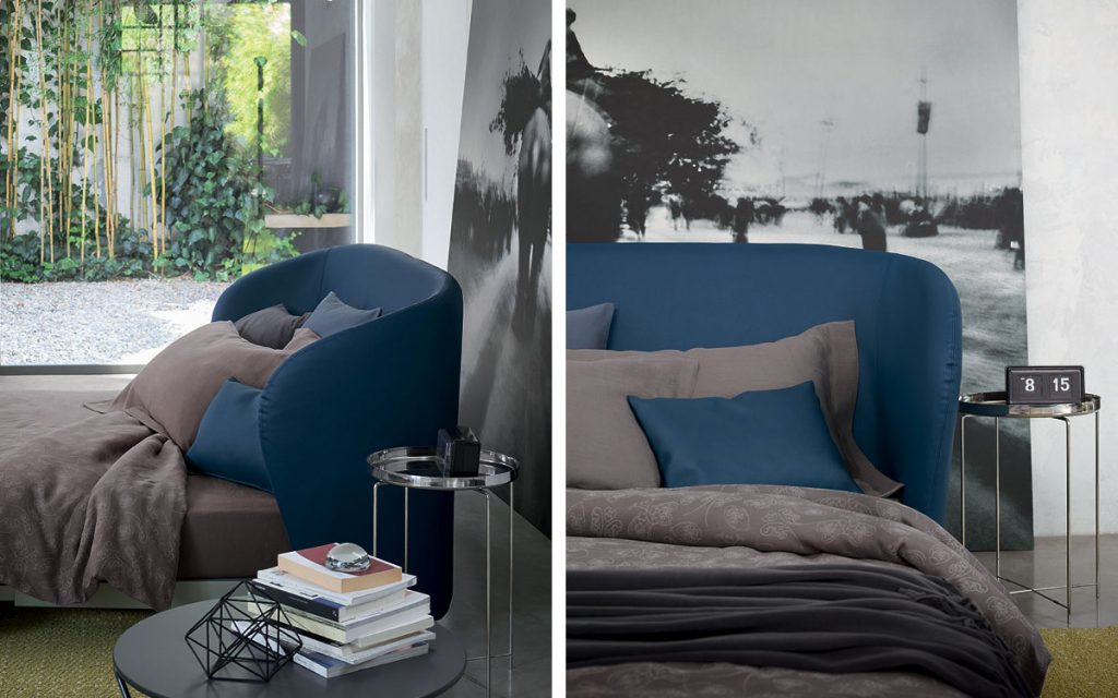 Two Celine Sofa Sleepers in white and blue brown bed top, pillows and wheels in a bedroom.