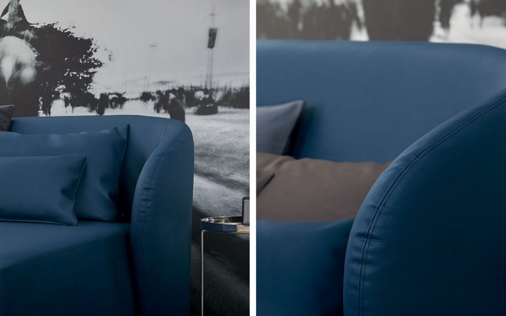 Two Celine Sofa Sleepers in white and blue brown bed top, pillows and wheels in a bedroom.