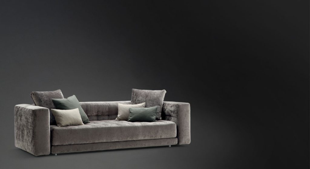 Doze composition A sofa made of gray fabric with legs on a black background.