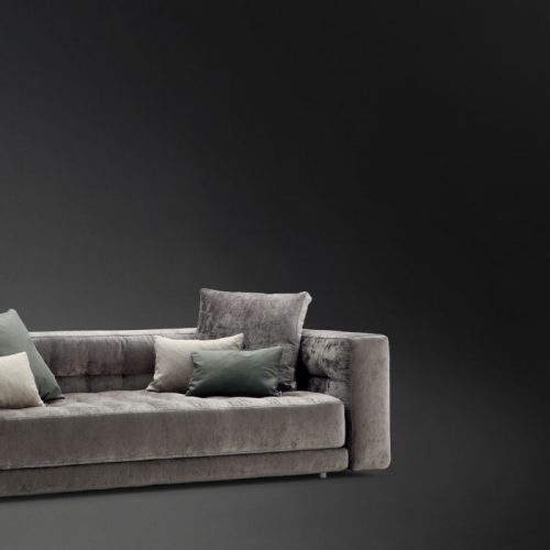 Doze composition A sofa made of gray fabric with legs on a black background.