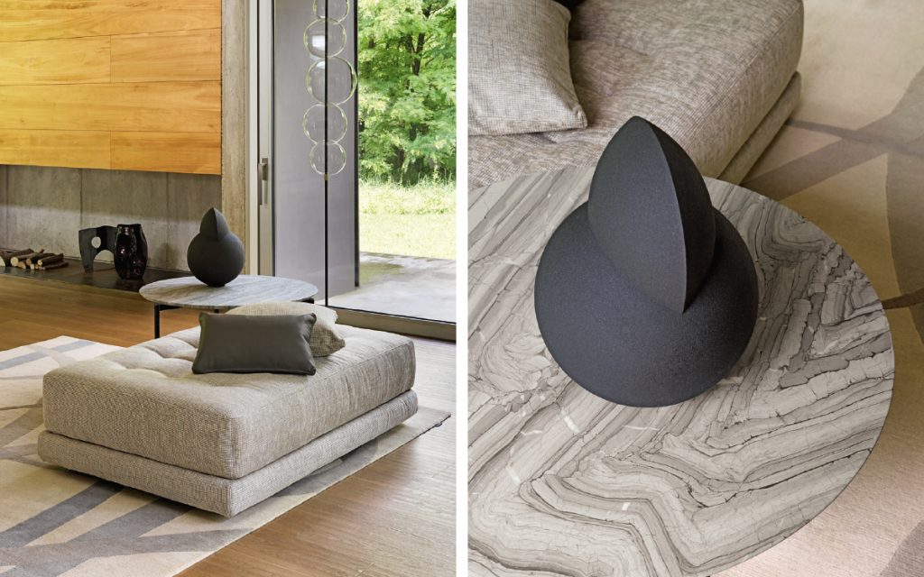 Closeup of Short L shaped Doze composition B sofa made of gray fabric with legs in a living room.