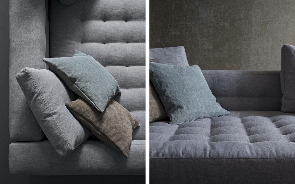 Closeup of Short L shaped Doze composition B sofa made of gray fabric with legs in a living room.