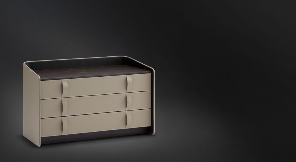 Gentleman Dresser Low. Curved wood with black cover and shelfs in ebany on a black bakground.