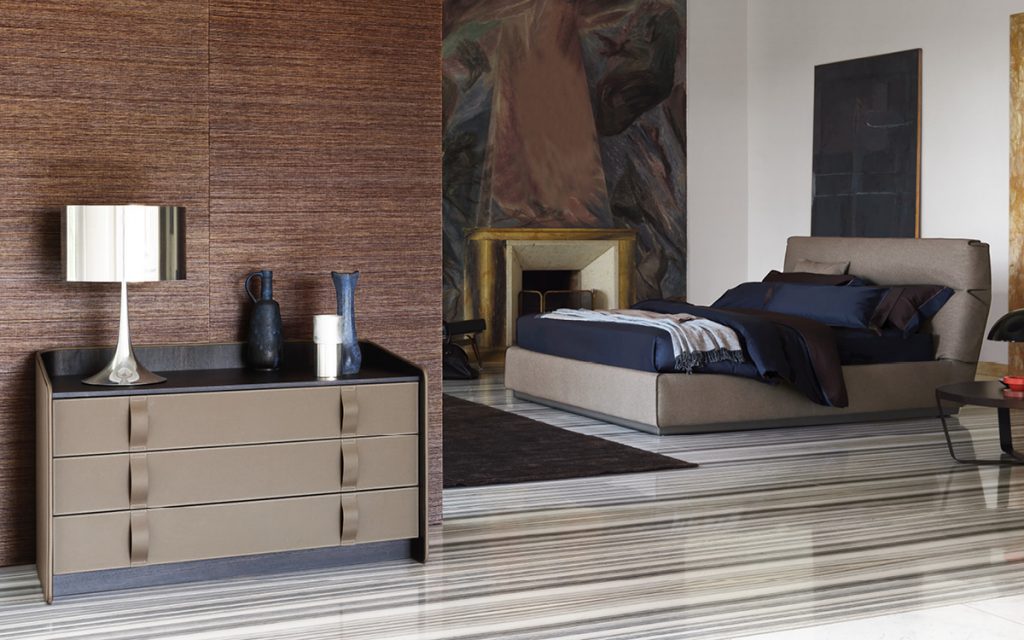 Gentleman Dresser Low. Curved black wood with cover and shelfs in brown in a bedroom.