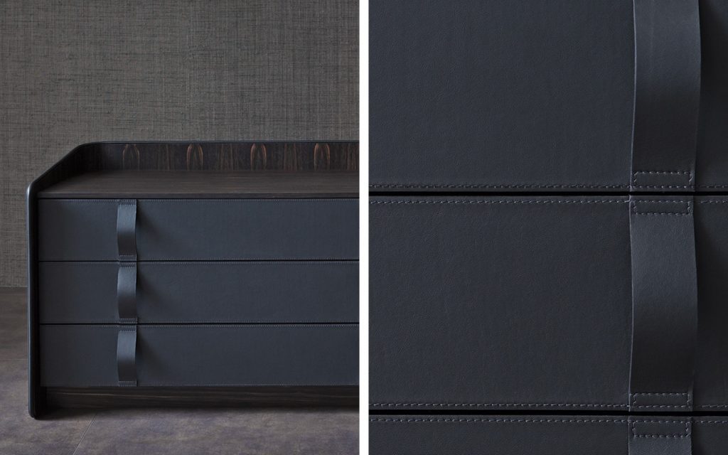 Closeup of Gentleman Dresser Low. Curved black wood with cover and shelfs in black in a bedroom.
