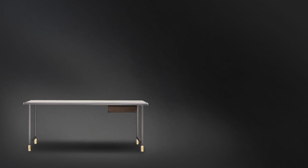 Rectangular Iko desk. Ebony top with a brown drawer below and legs on a black background.