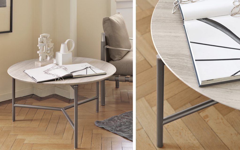 Closeup of Iko Side Table, top in gray marble with black legs in a living room.