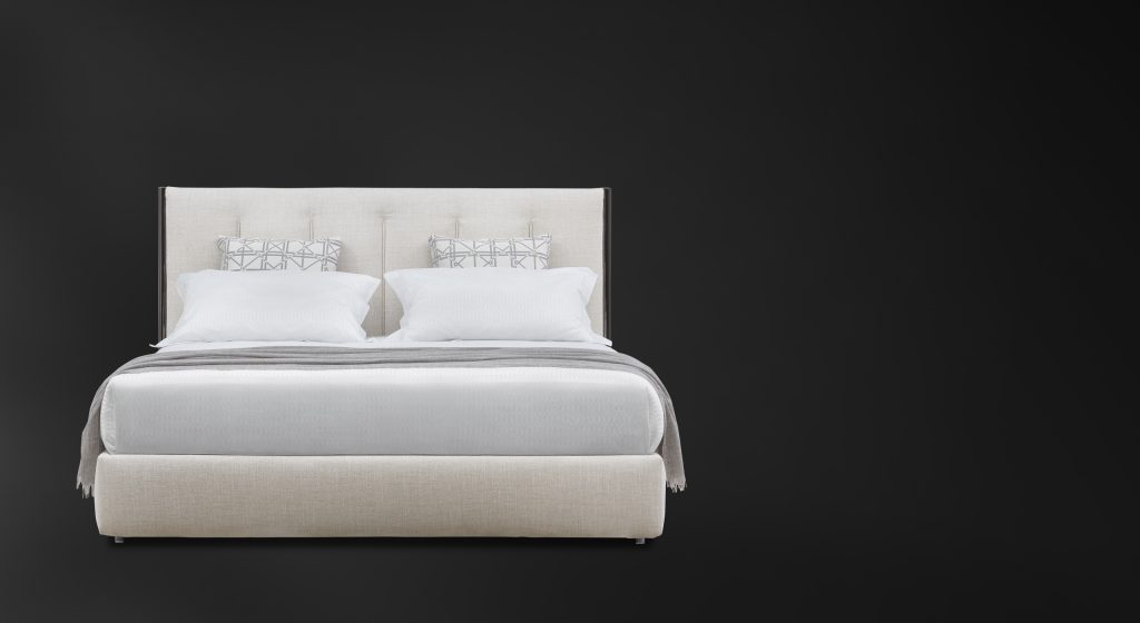 Koi double size bed upholstered in white fabric, heardboard with vertical lines pattern on a black background.