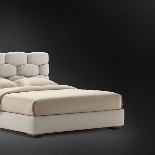 Beige Majal Double bed. Geometric shapes on the headboard and bedding on a black background.