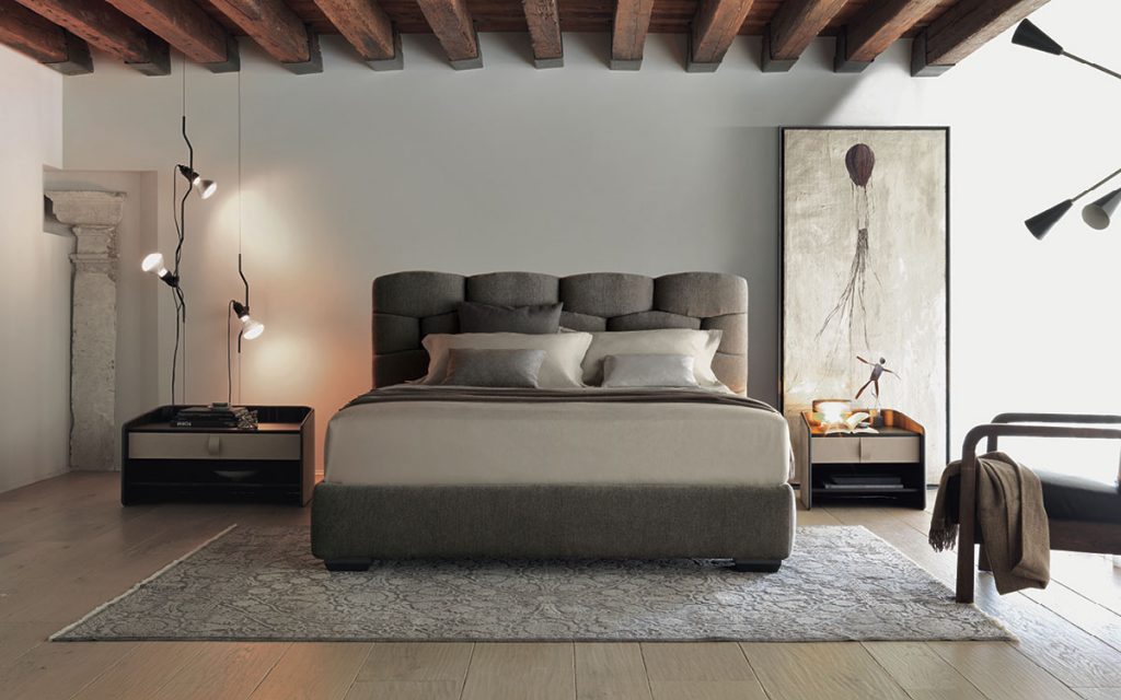 Gray Majal Double bed. Geometric shapes on the headboard and bedding in a bedroom.