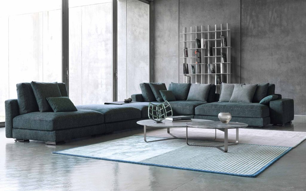 Myplace A: L shaped green modular sofa with black legs, in a living room setting.