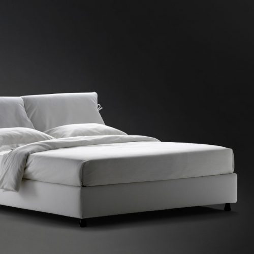 Nathalie Double bed white headboard cushions and gray base with black legs on a black background.