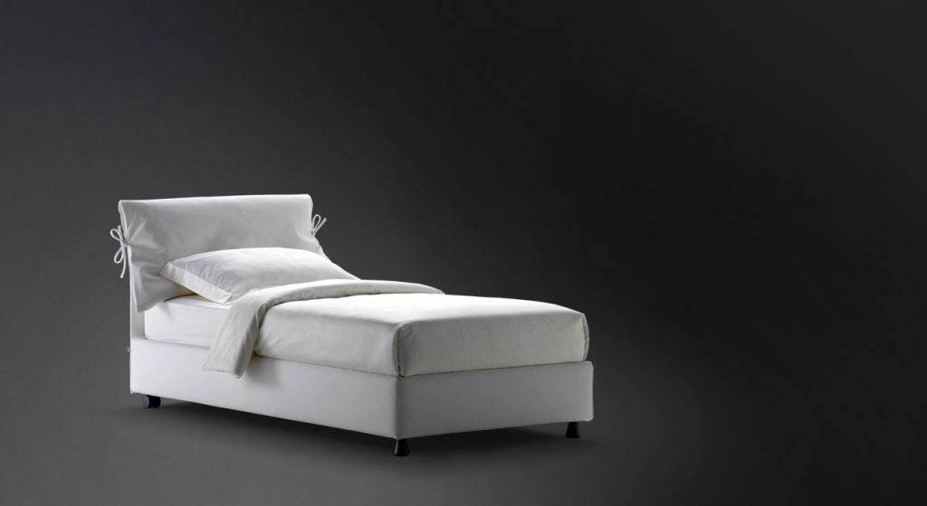 Nathalie Single bed white headboard cushions and gray base with black legs on a black background.
