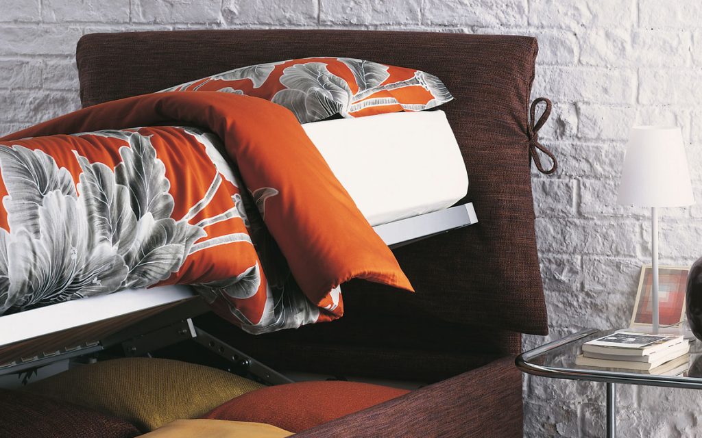 Nathalie Single bed purple headboard cushions and purple base with black legs and bedding in a bedroom.