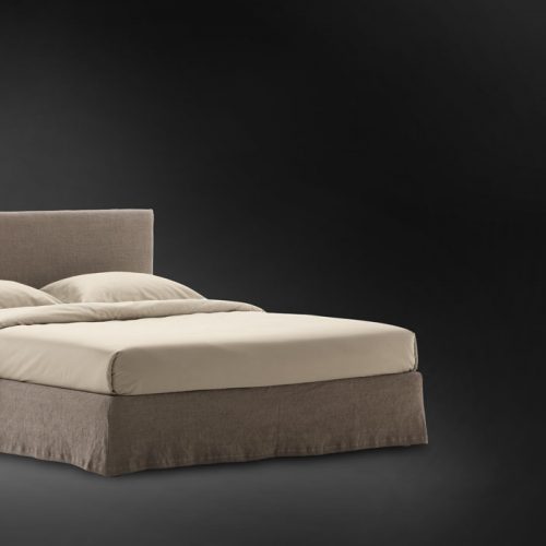 Notturno Shabby Chic bed. Base and backrest covered in gray fabric on a black background.