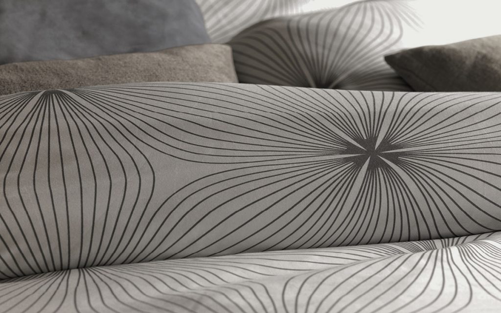 Closeup of Notturno Shabby Chic white bedding with gray flower pattern.