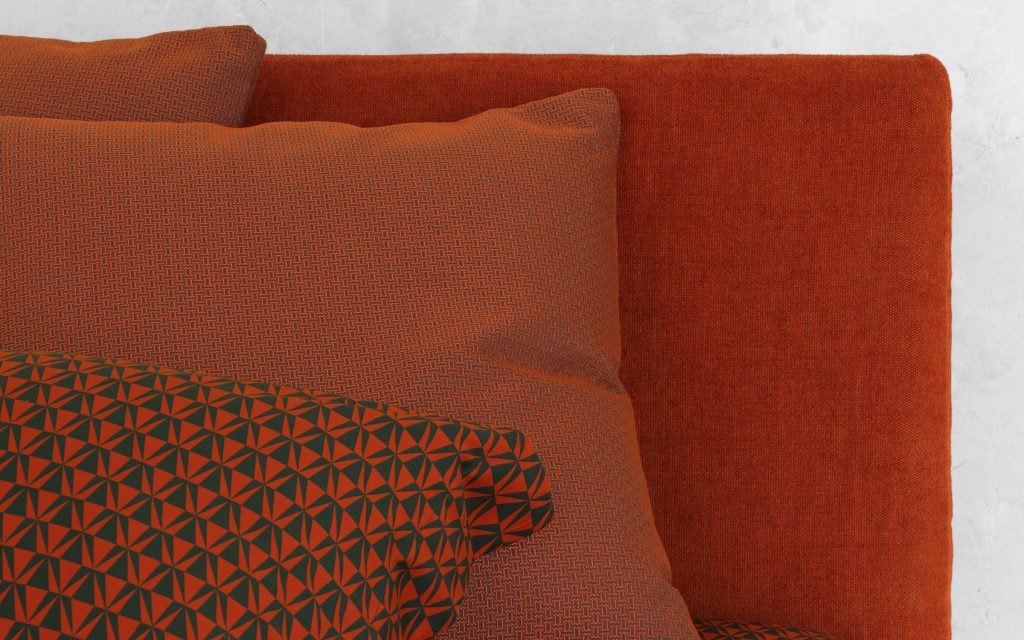 Closeup of Notturno Single bed. Base and backrest covered in red fabric with bedding in a bedroom.