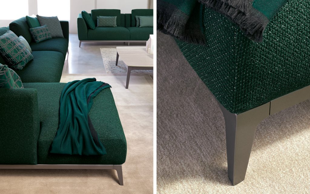 Closeup of two Olivier C sofas upholstered in green fabric and four legs in steel in a living room.