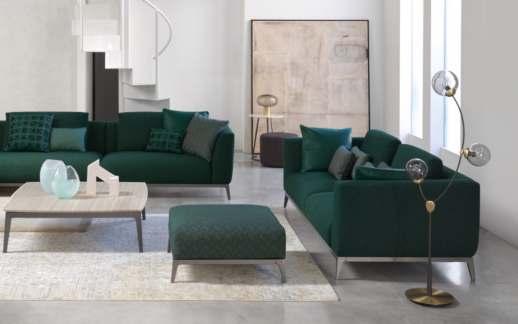 Two Olivier D sofas upholstered in green fabric and four legs in steel in a living room.
