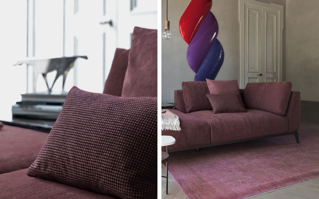 Closeup of Olivier D sofa upholstered in purple fabric and four legs in steel in a living room.