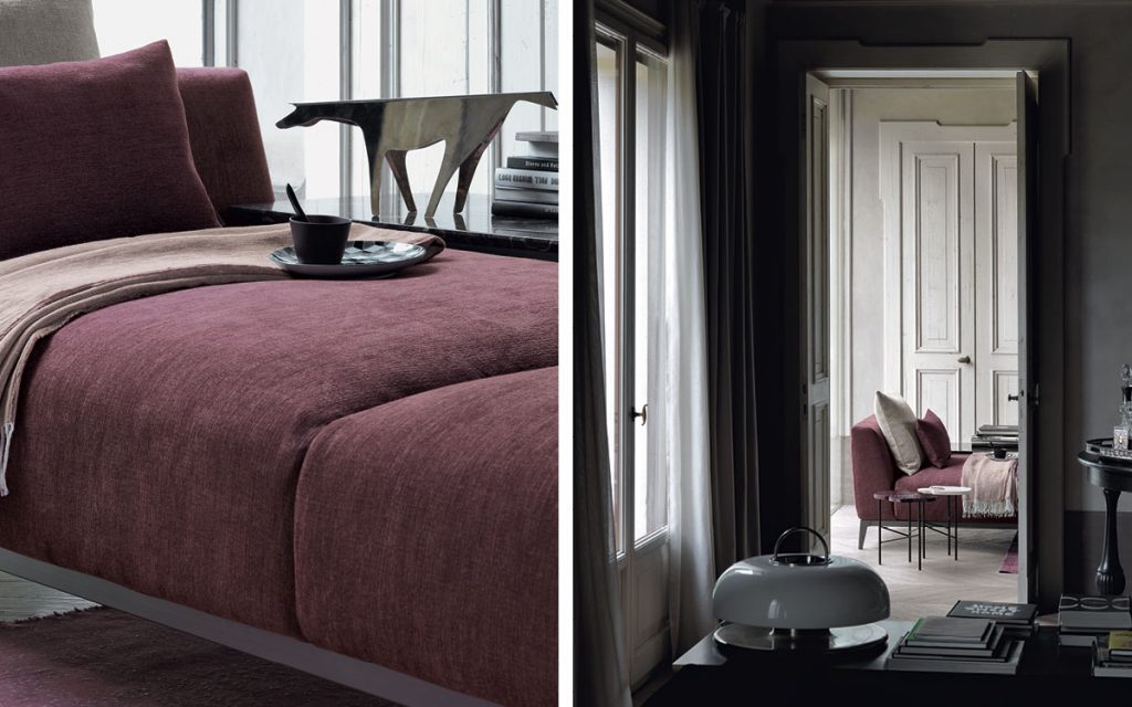 Closeup of Olivier D sofa upholstered in purple fabric and four legs in steel in a living room.