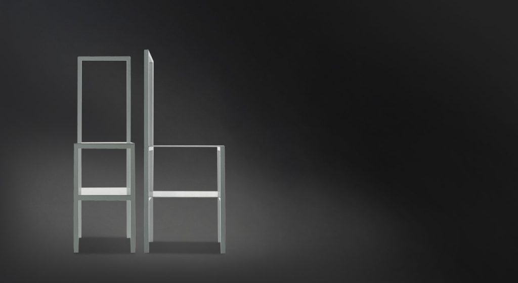 Two white Servomuto with double function chair/coat stand on a black background.
