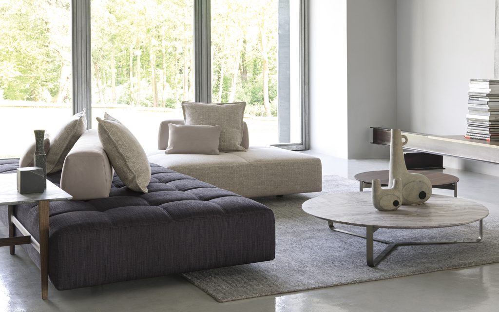 Two Softbench one hundred fifty gray wide square modular sofas in a living room.