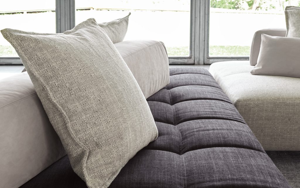 Two Softbench one hundred fifty gray wide square modular sofas in a living room.